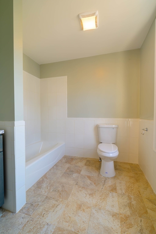 28-30 Chestnut Avenue, Unit 3 Boston, MA 02130 - Photo 8 of 17 a white toilet sitting next to a bathroom sink