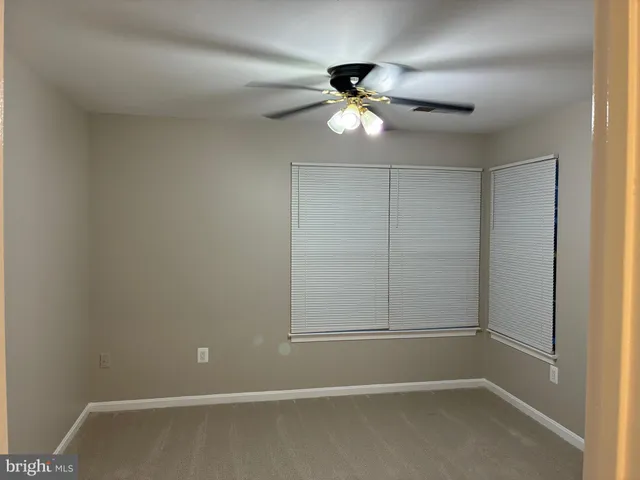 a view of an empty room with a fan