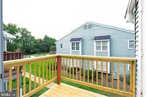 a view of a house with a wooden deck
