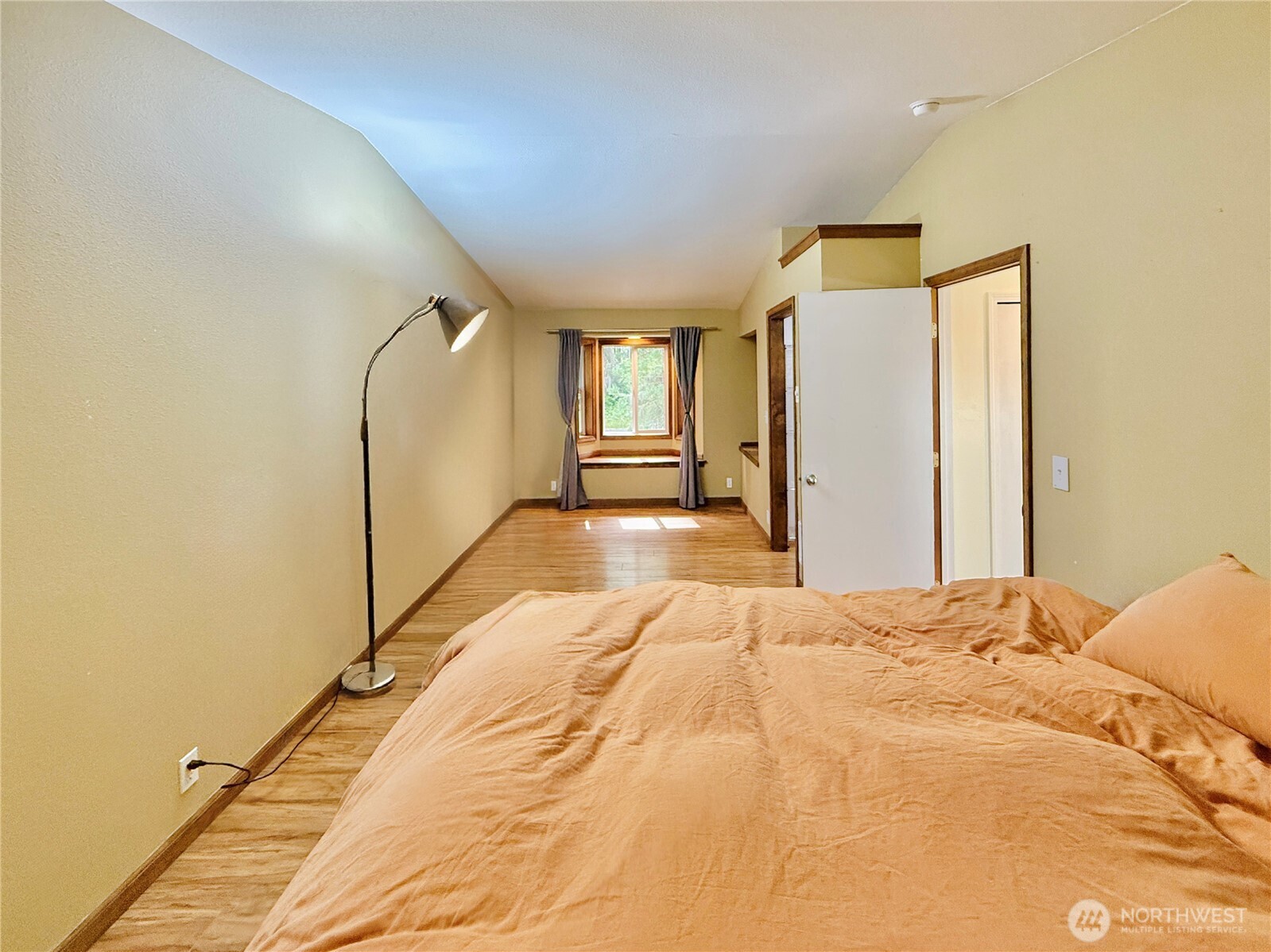 11422 Leschi Circle Anderson Island, WA 98303 - Photo 14 of 40 a view of a bedroom with a bed and wooden floor
