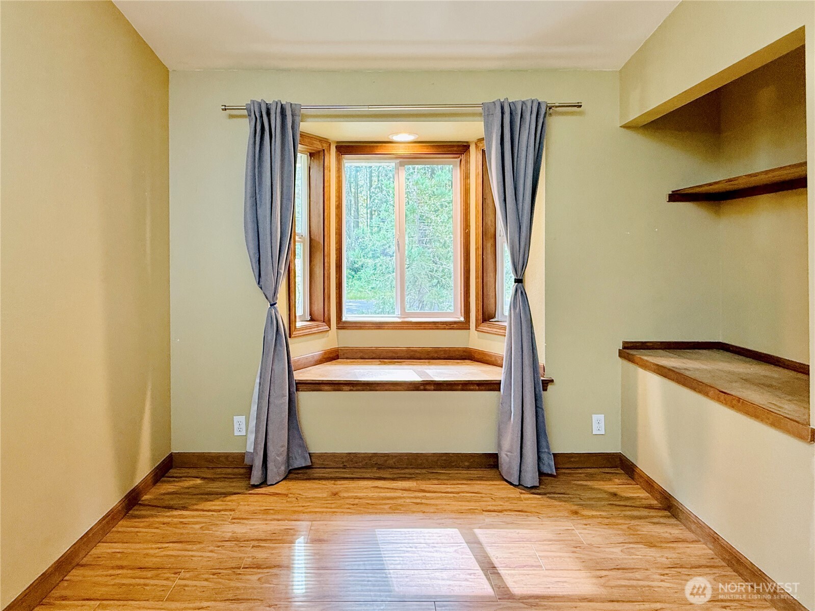 11422 Leschi Circle Anderson Island, WA 98303 - Photo 15 of 40 a view of a room with wooden floor and a window