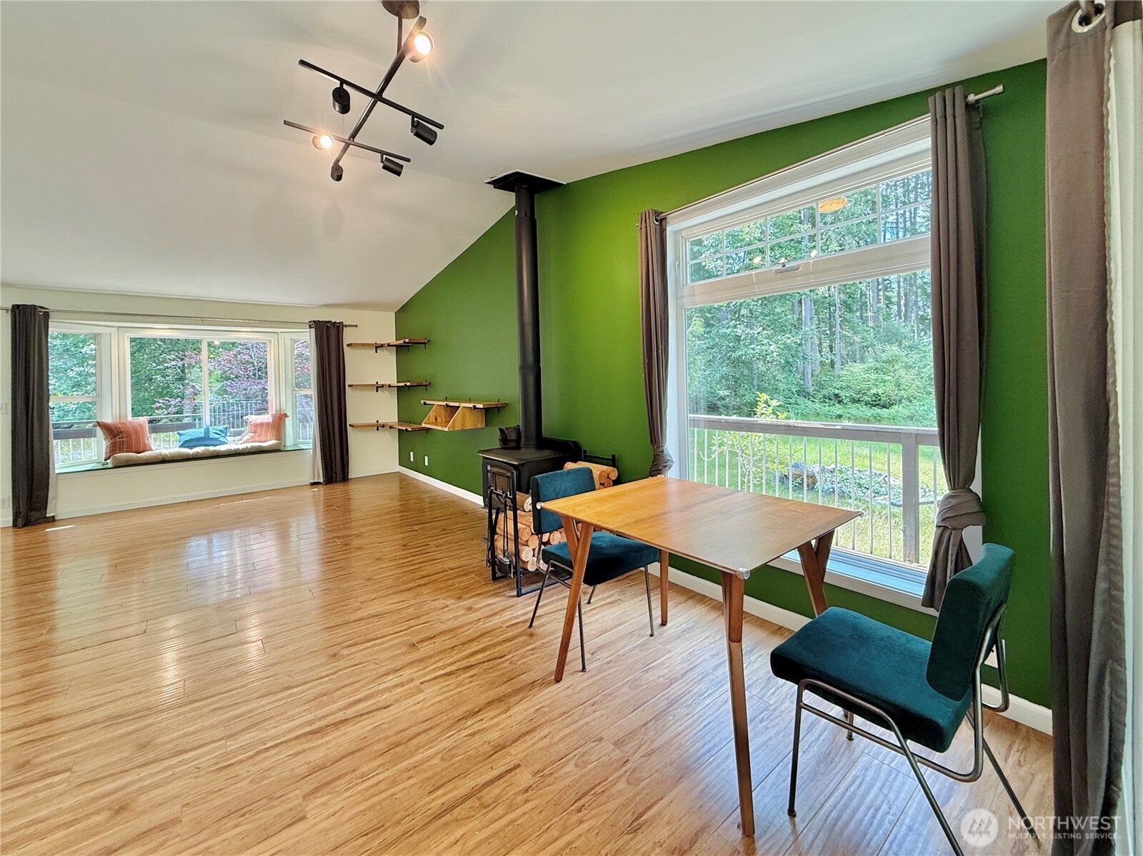 11422 Leschi Circle Anderson Island, WA 98303 - Photo 7 of 40 a dining room with wooden floor a chandelier a glass table and chairs