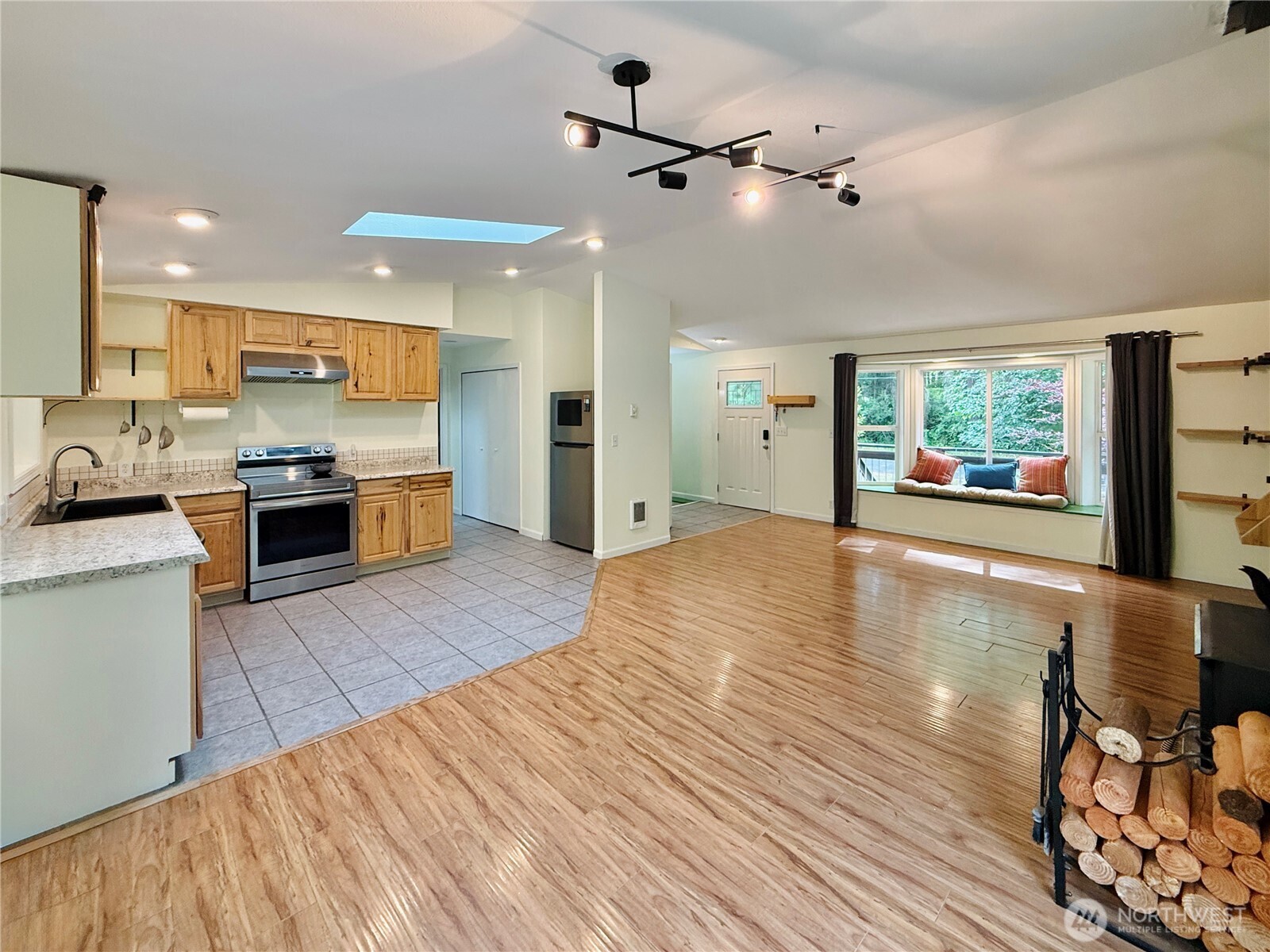 11422 Leschi Circle Anderson Island, WA 98303 - Photo 9 of 40 a large kitchen with stainless steel appliances a large counter top a stove a chimney a sink and a large window
