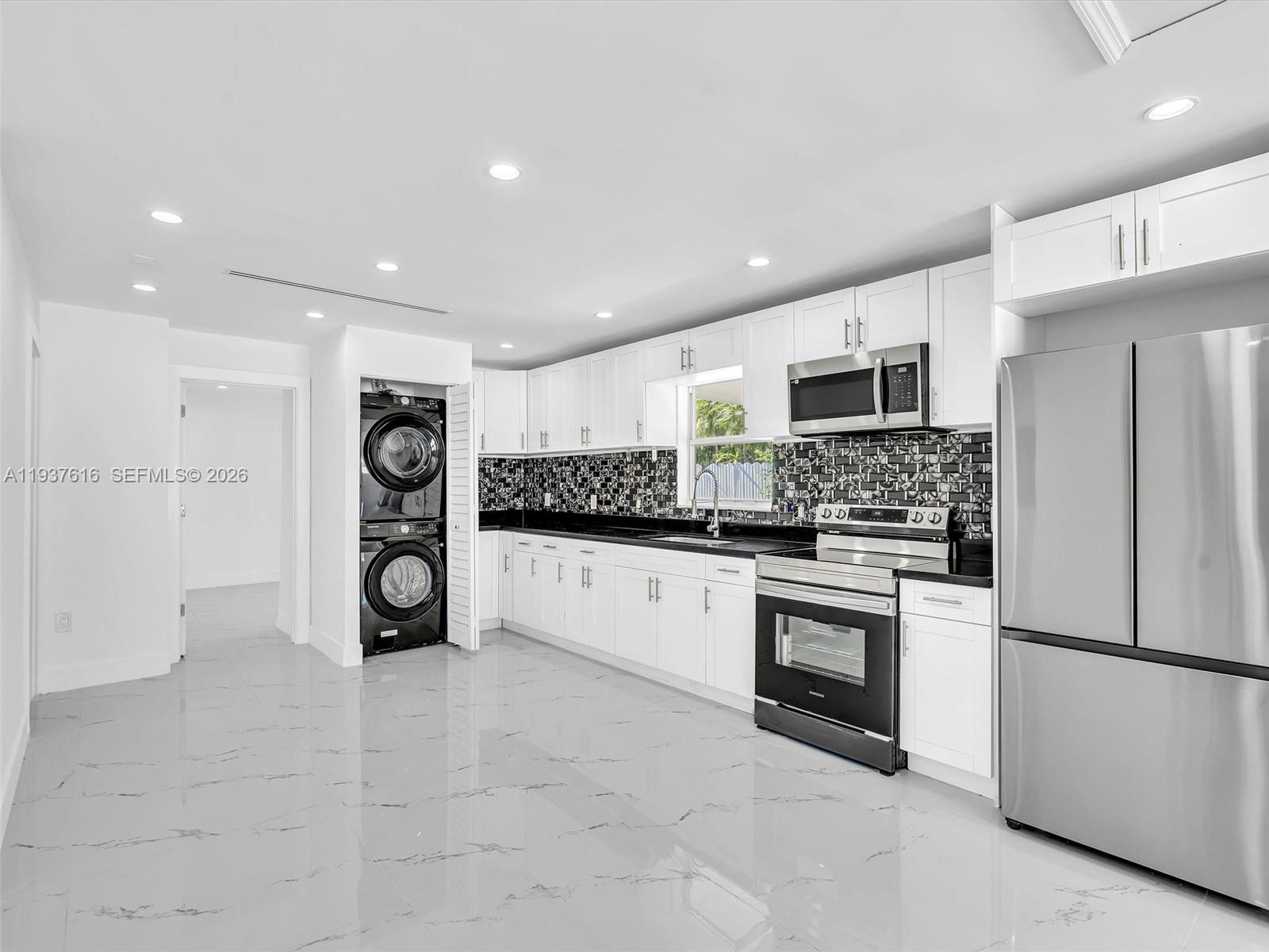 3354 Northwest 50th Street, Unit 3354 Miami, FL 33142 - Photo 11 of 26 a kitchen with a refrigerator and a stove top oven