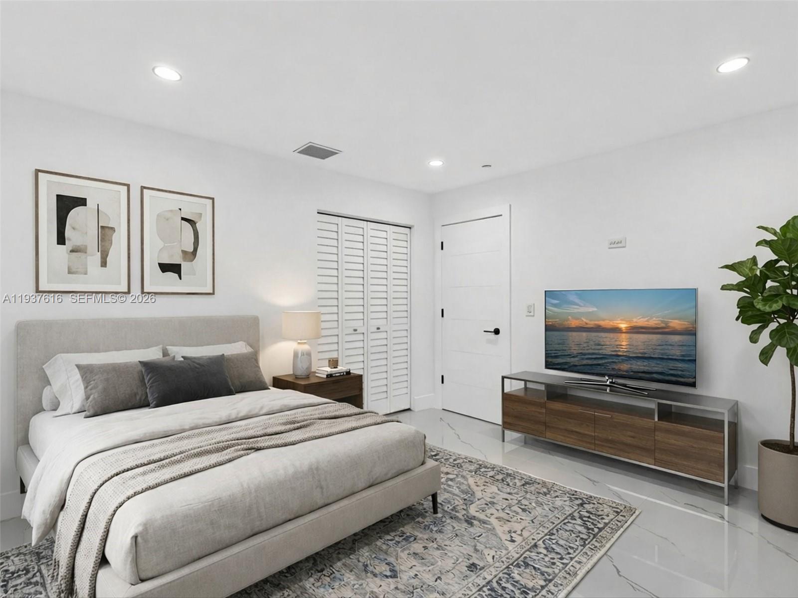 3354 Northwest 50th Street, Unit 3354 Miami, FL 33142 - Photo 15 of 26 a bedroom with a bed and a flat screen tv