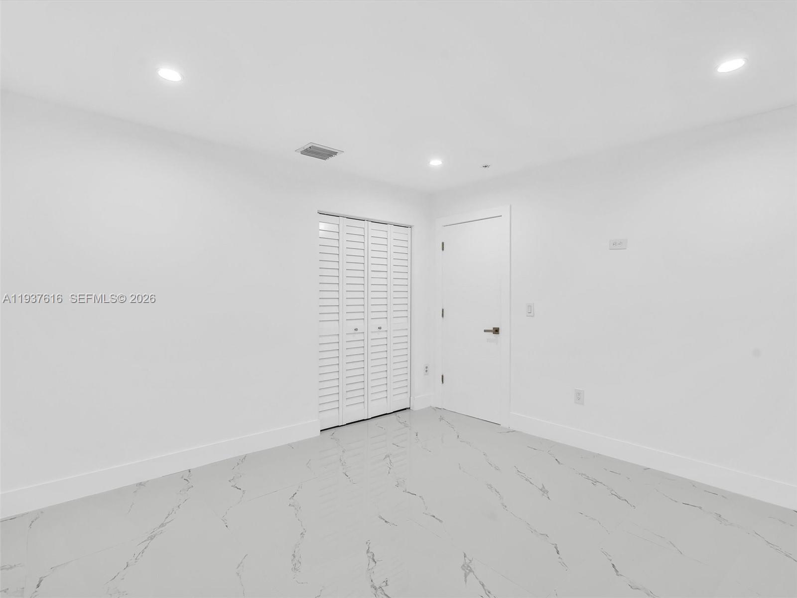 3354 Northwest 50th Street, Unit 3354 Miami, FL 33142 - Photo 16 of 26 an empty room with white walls and tiles