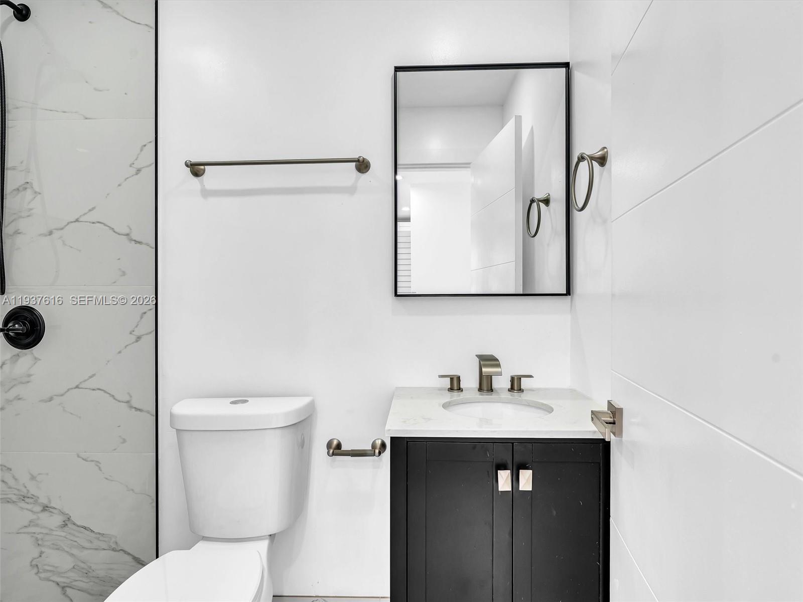 3354 Northwest 50th Street, Unit 3354 Miami, FL 33142 - Photo 24 of 26 a bathroom with a sink and a toilet