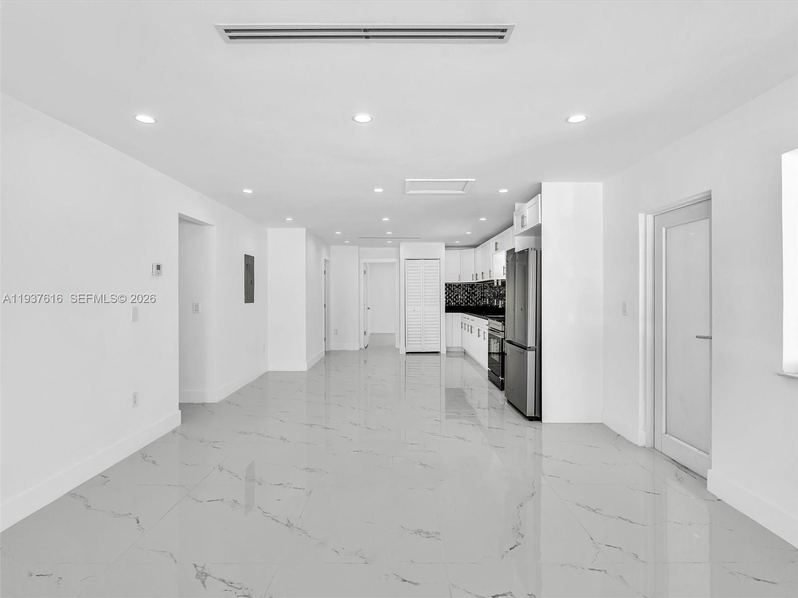3354 Northwest 50th Street, Unit 3354 Miami, FL 33142 - Photo 3 of 26 a view of a refrigerator in kitchen and a window