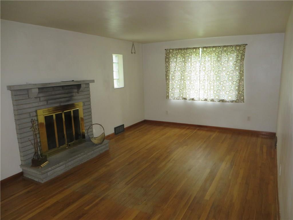 137 Poplar Ridge Road Penn Hills, PA 15235 - Photo 6 of 25 Large living room with hardwood floors and working fireplace