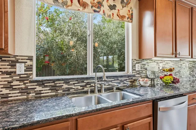 a living room with furniture a fireplace and a floor to ceiling window