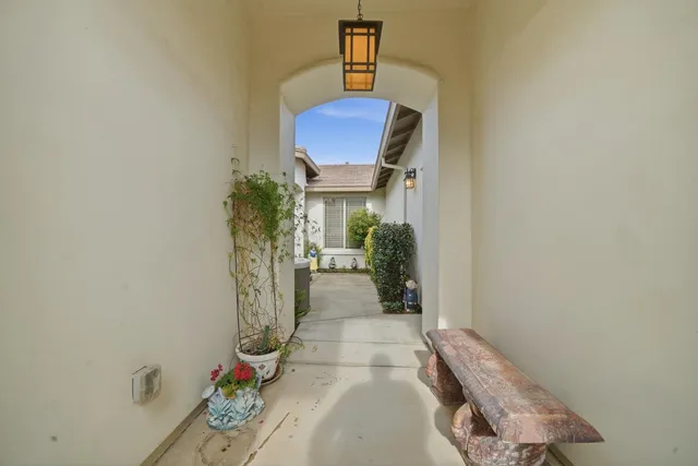 a view of a hallway with wooden floor and entryway