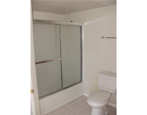 15010 Leeward Drive, Unit 107 Corpus Christi, TX 78418 - Photo 4 of 7 a white toilet sitting next to a shower