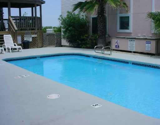 15010 Leeward Drive, Unit 107 Corpus Christi, TX 78418 - Photo 7 of 7 a view of a house with pool and sitting area