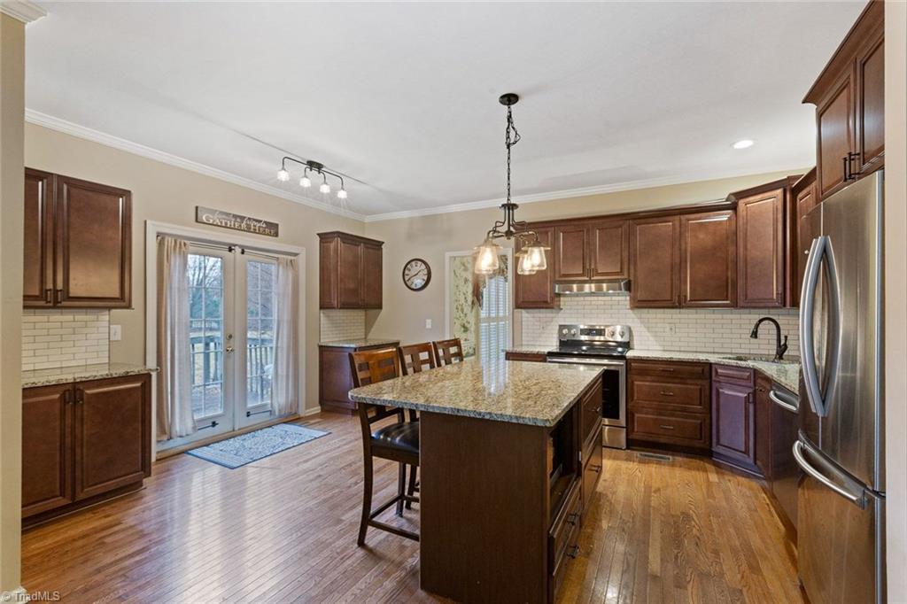 4911 Devane Court High Point, NC 27265 - Photo 8 of 27 Updated kitchen with wood laminate floors and granite counter tops