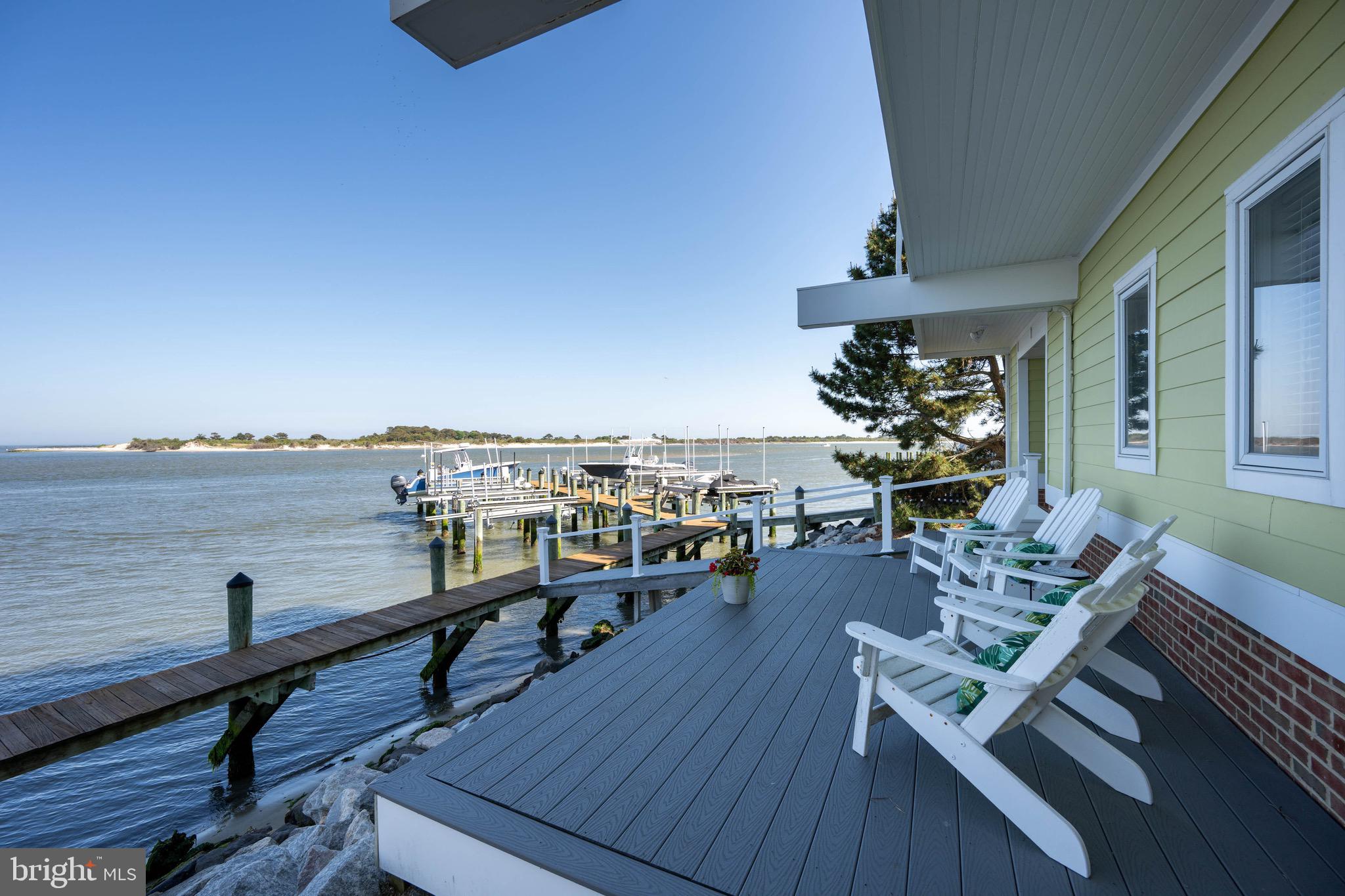 12959 Harbor Road Ocean City, MD 21842 - Photo 51 of 85 a view of a balcony with chairs and wooden floor