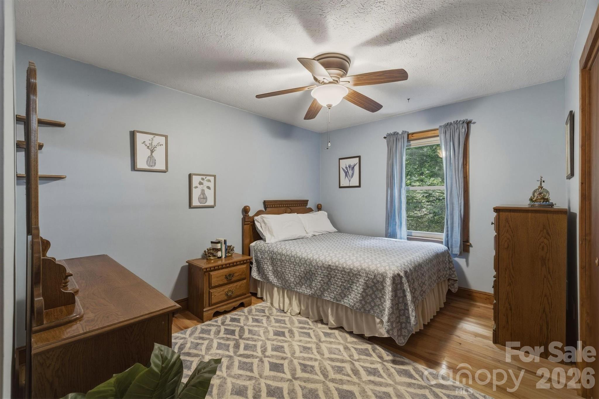3432 Ridgewood Drive Morganton, NC 28655 - Photo 20 of 36 a bedroom with a bed and wooden floor