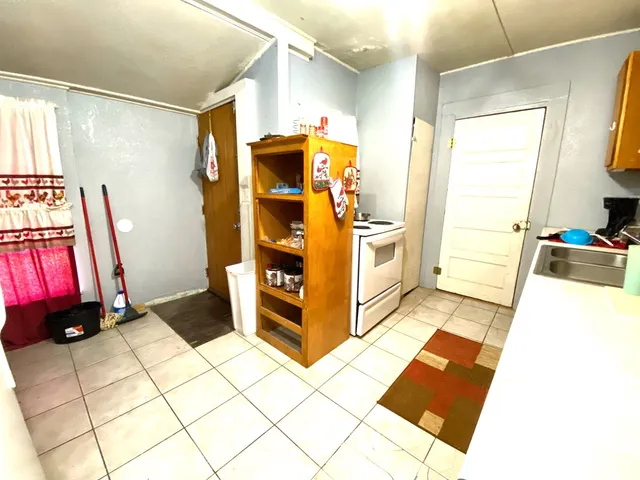 a kitchen with stainless steel appliances kitchen island granite countertop a refrigerator and a stove