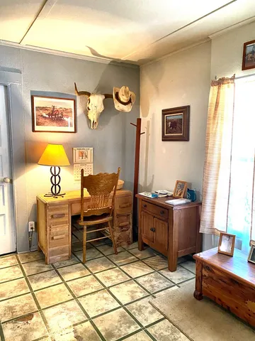 a bedroom with furniture and a window