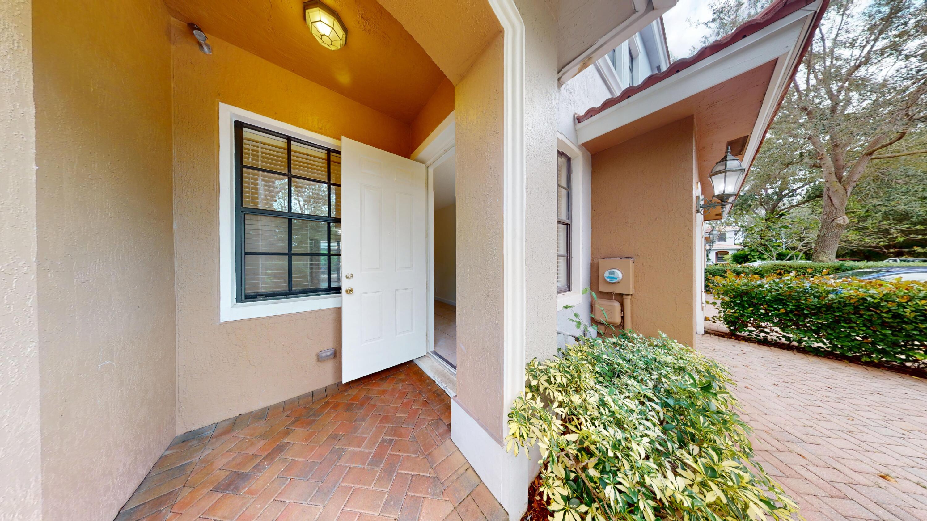 235 Chrystie Circle Delray Beach, FL 33484 - Photo 3 of 27 a front view of a house with a yard
