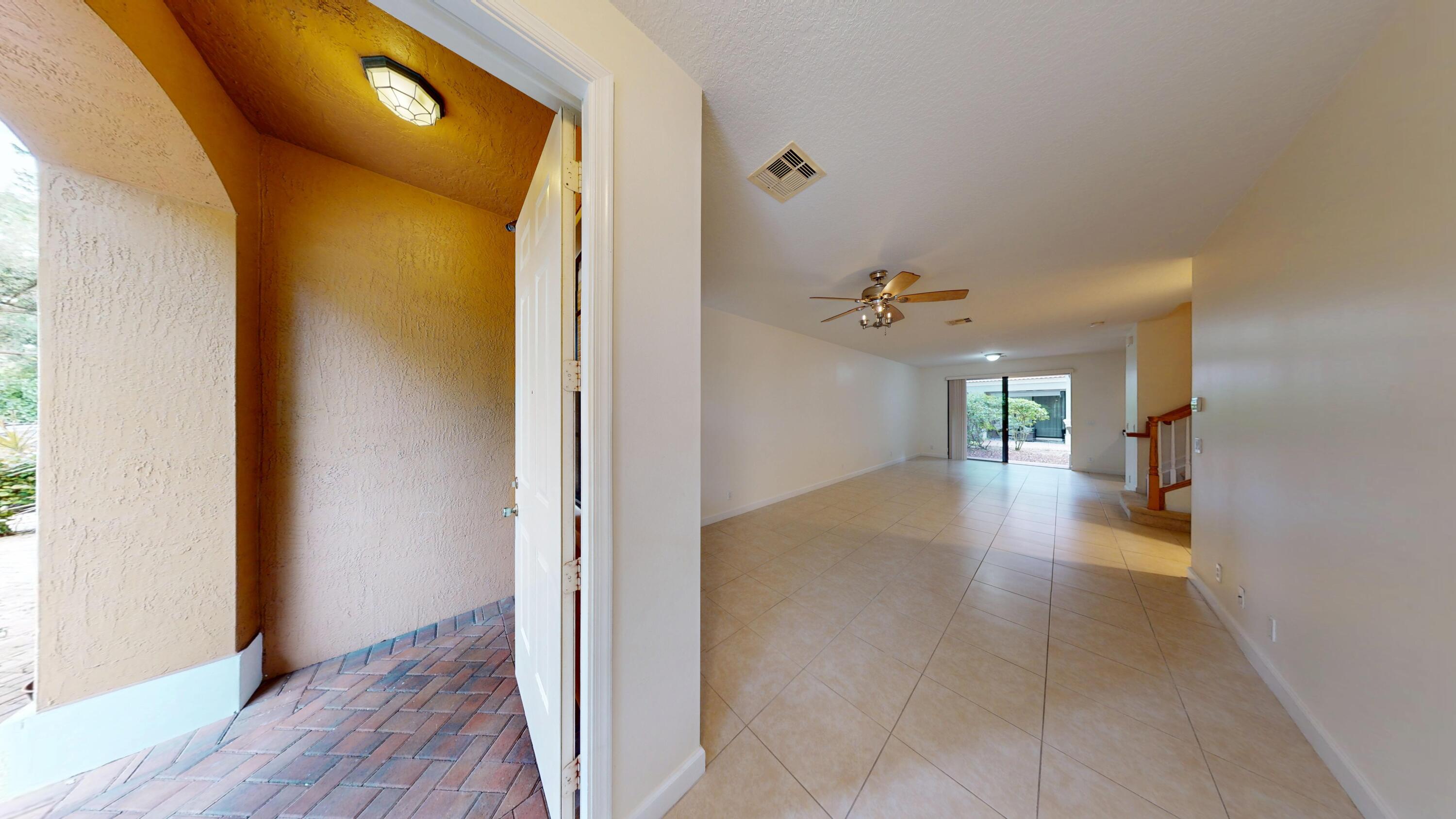 235 Chrystie Circle Delray Beach, FL 33484 - Photo 4 of 27 a view of a hallway with wooden floor