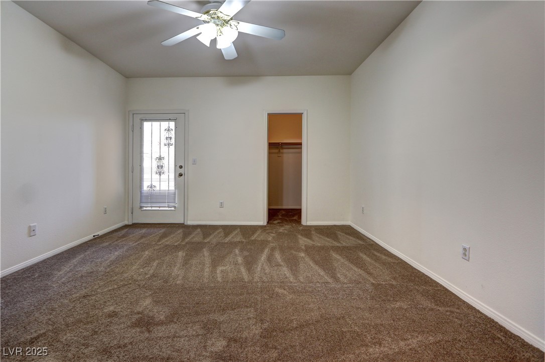 3555 Meridale Drive, Unit 2153 Las Vegas, NV 89147 - Photo 12 of 24 Unfurnished bedroom featuring carpet floors, a walk in closet, and ceiling fan