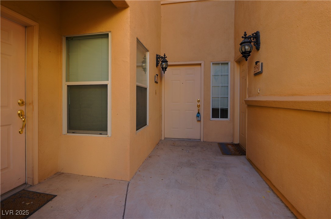 3555 Meridale Drive, Unit 2153 Las Vegas, NV 89147 - Photo 2 of 24 View of exterior entry with a patio and stucco siding