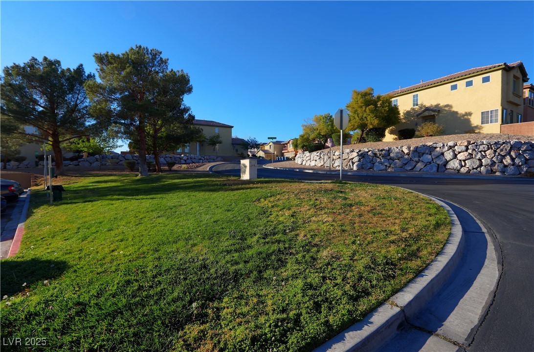 3555 Meridale Drive, Unit 2153 Las Vegas, NV 89147 - Photo 23 of 24 View of asphalt road with curbs and traffic signs