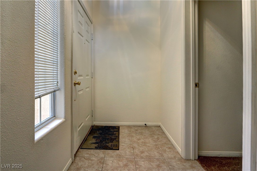 3555 Meridale Drive, Unit 2153 Las Vegas, NV 89147 - Photo 3 of 24 Entryway with a textured wall and tile patterned floors