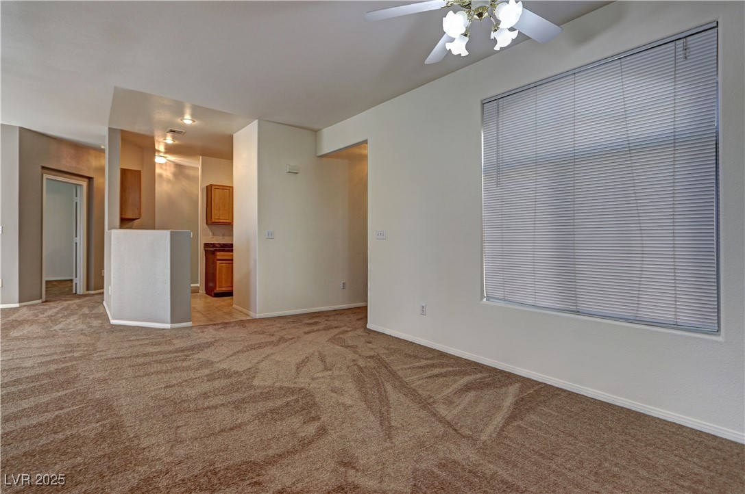 3555 Meridale Drive, Unit 2153 Las Vegas, NV 89147 - Photo 9 of 24 Empty room featuring light colored carpet and baseboards