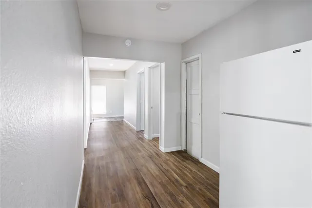 a view of hallway with wooden floor