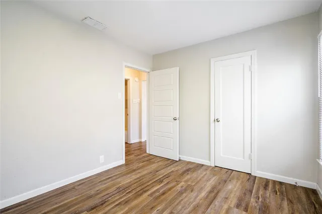 a view of an empty room and wooden floor