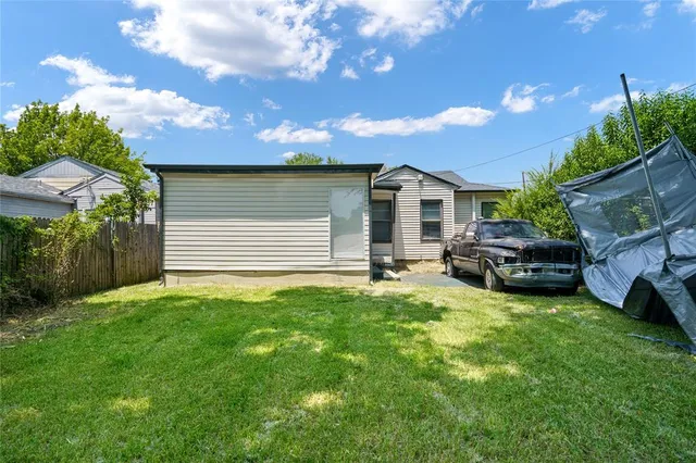 a front view of a house with a garden and yard