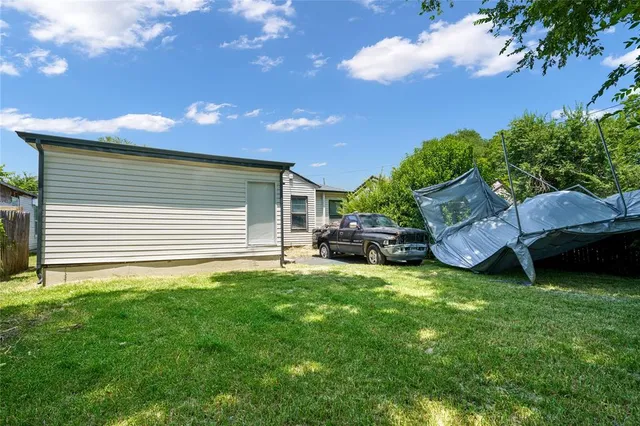 a backyard of a house with table and chairs