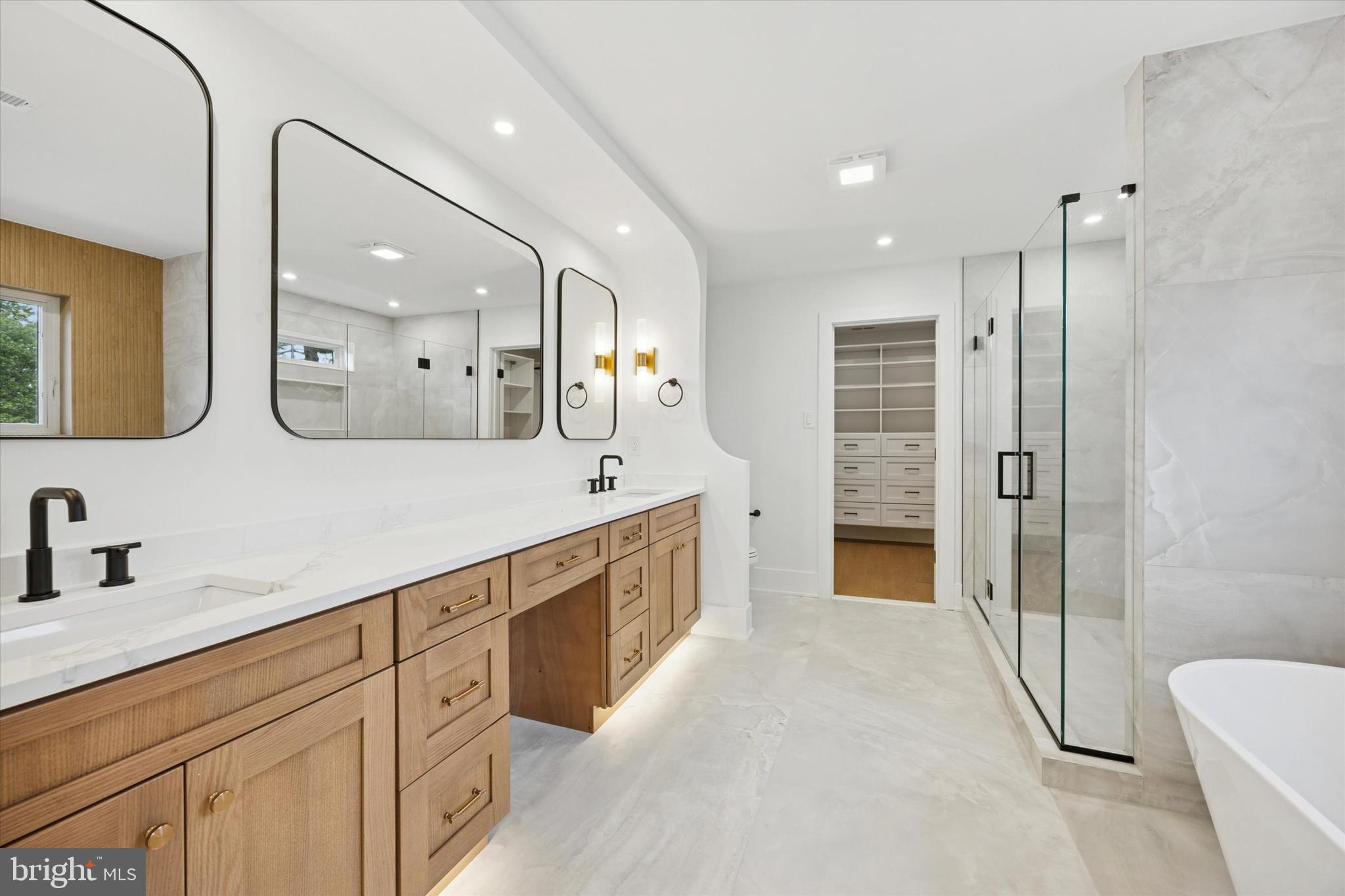 631 Pardee Lane Haddonfield, NJ 08033 - Photo 14 of 37 a spacious bathroom with a double vanity sink a large mirror and shower