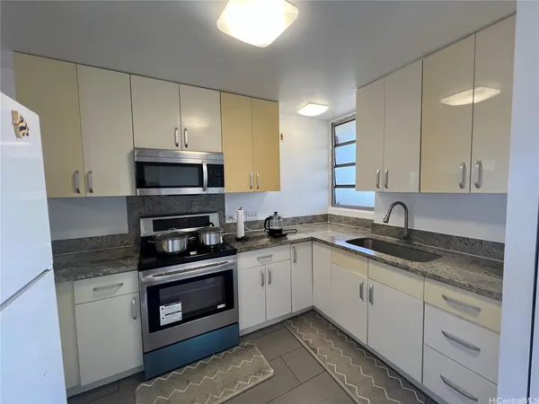 a kitchen with stainless steel appliances granite countertop a sink and a stove