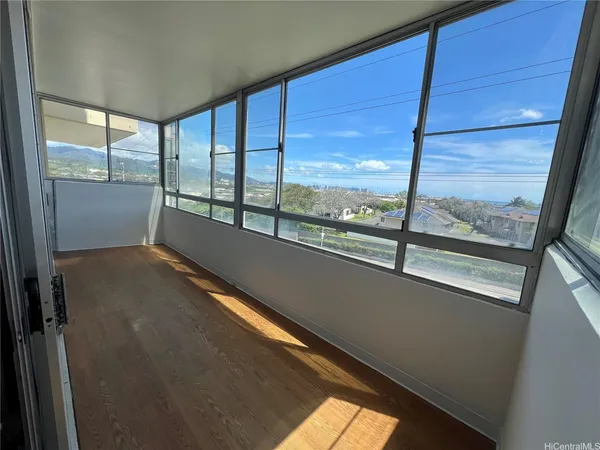a view of an empty room with large windows