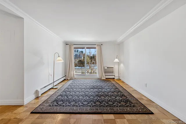 wooden floor in an empty room with a rug