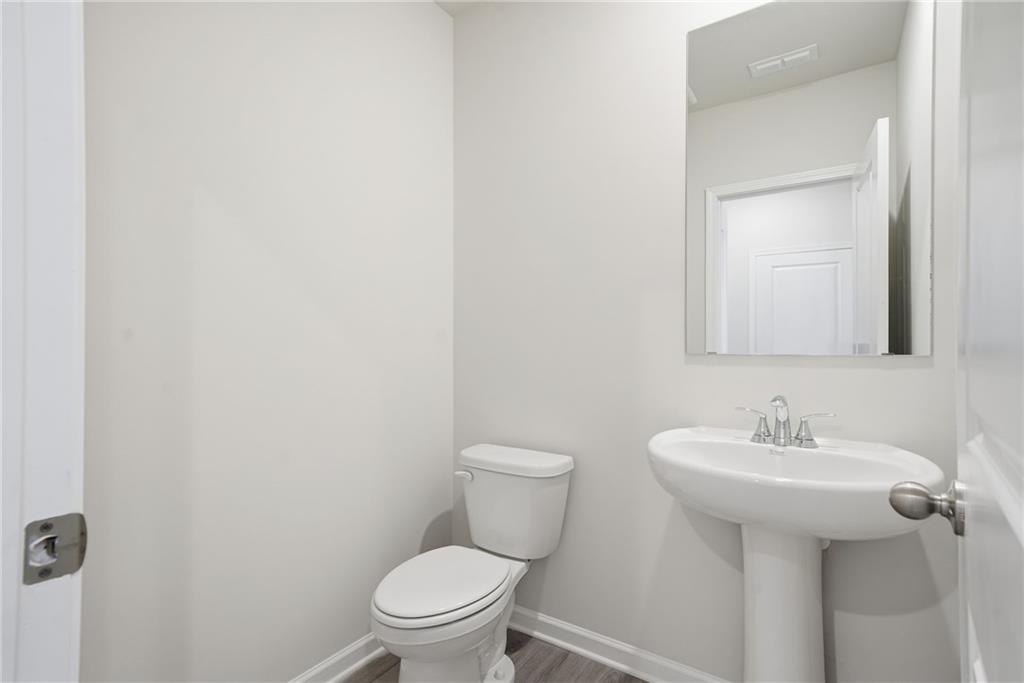 1503 Wild Fox Run Lawrenceville, GA 30045 - Photo 15 of 46 a bathroom with a toilet sink and mirror