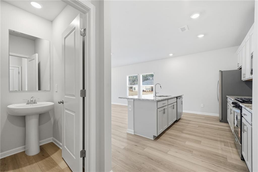 1503 Wild Fox Run Lawrenceville, GA 30045 - Photo 16 of 46 a kitchen with white cabinets and sink