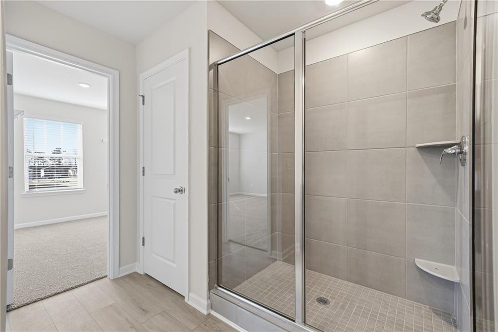 1503 Wild Fox Run Lawrenceville, GA 30045 - Photo 22 of 46 a bathroom with a glass shower door