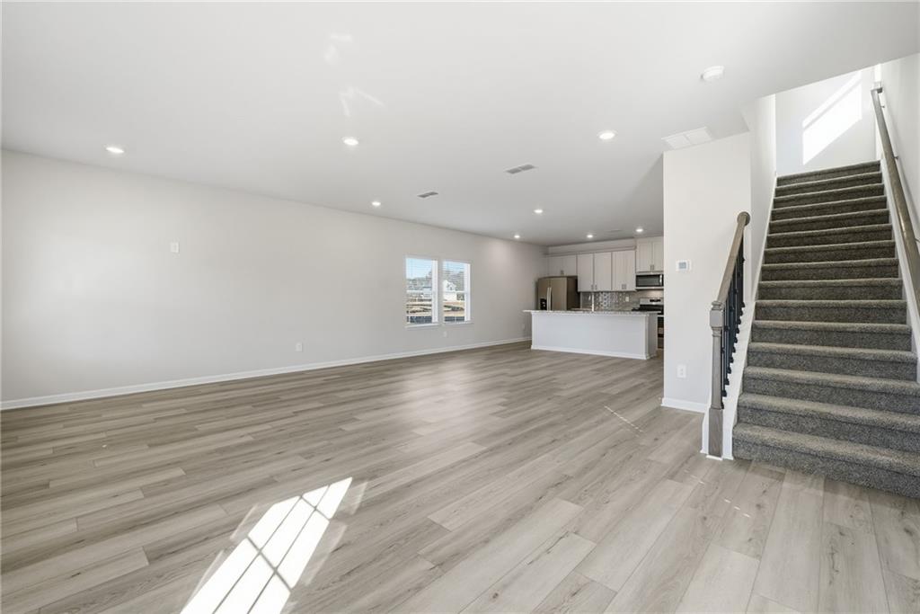 1503 Wild Fox Run Lawrenceville, GA 30045 - Photo 3 of 46 a view of a kitchen with wooden floor and staircase