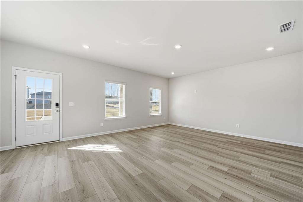 1503 Wild Fox Run Lawrenceville, GA 30045 - Photo 4 of 46 wooden floor in an empty room with a window