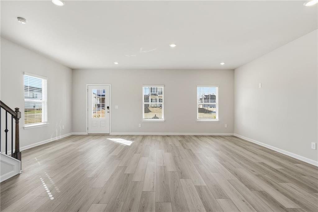 1503 Wild Fox Run Lawrenceville, GA 30045 - Photo 5 of 46 an empty room with wooden floor and windows