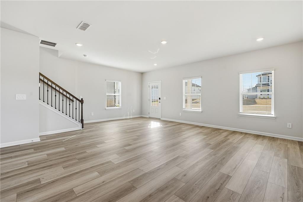 1503 Wild Fox Run Lawrenceville, GA 30045 - Photo 6 of 46 a view of an empty room with wooden floor and a window
