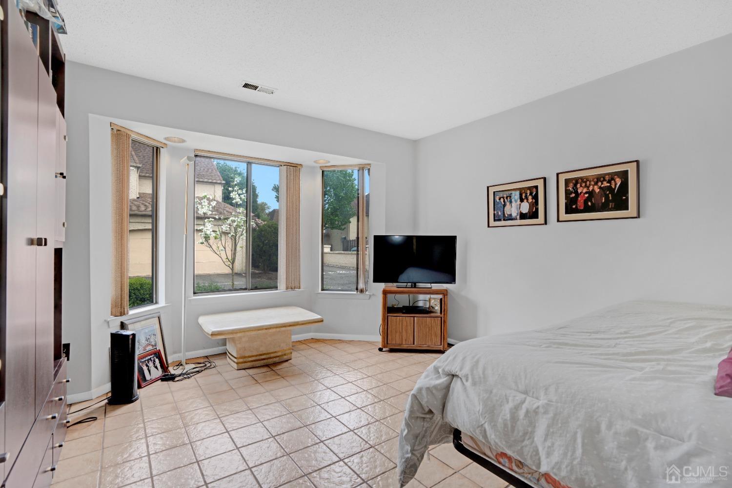 58 Gate House Lane Edison, NJ 08820 - Photo 14 of 37 a bed room with a bed and a television