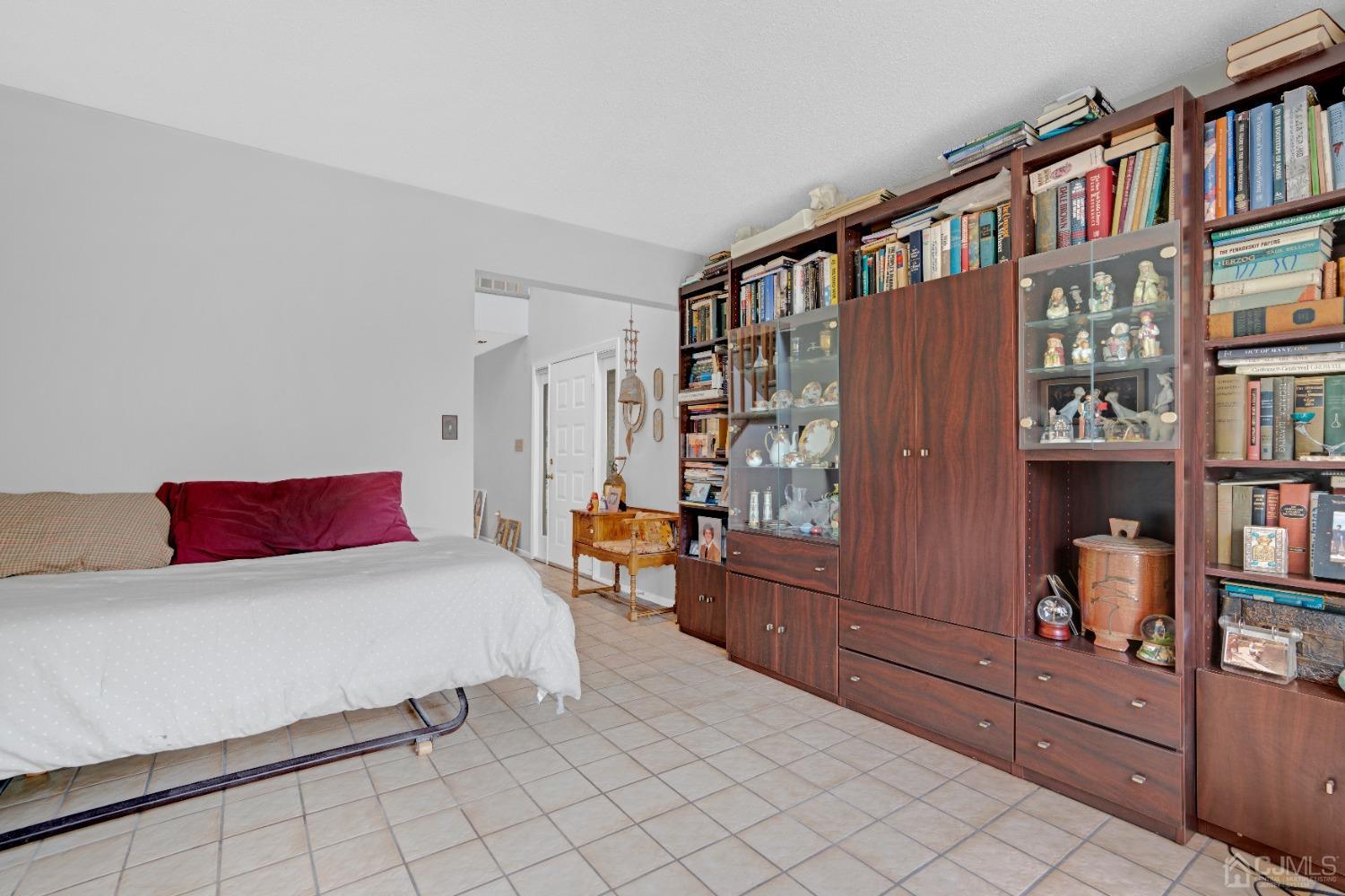 58 Gate House Lane Edison, NJ 08820 - Photo 15 of 37 a bedroom with a bed and a book shelf