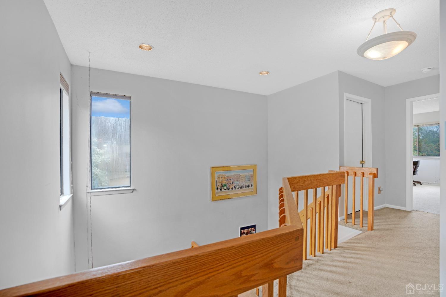 58 Gate House Lane Edison, NJ 08820 - Photo 17 of 37 a view of a hallway with wooden floor and staircase