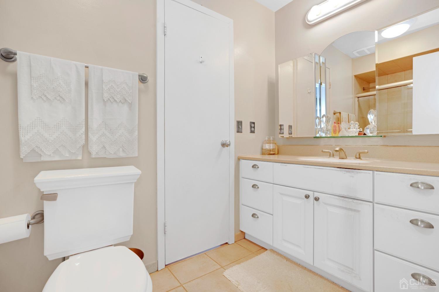 58 Gate House Lane Edison, NJ 08820 - Photo 25 of 37 a bathroom with a granite countertop toilet sink and mirror
