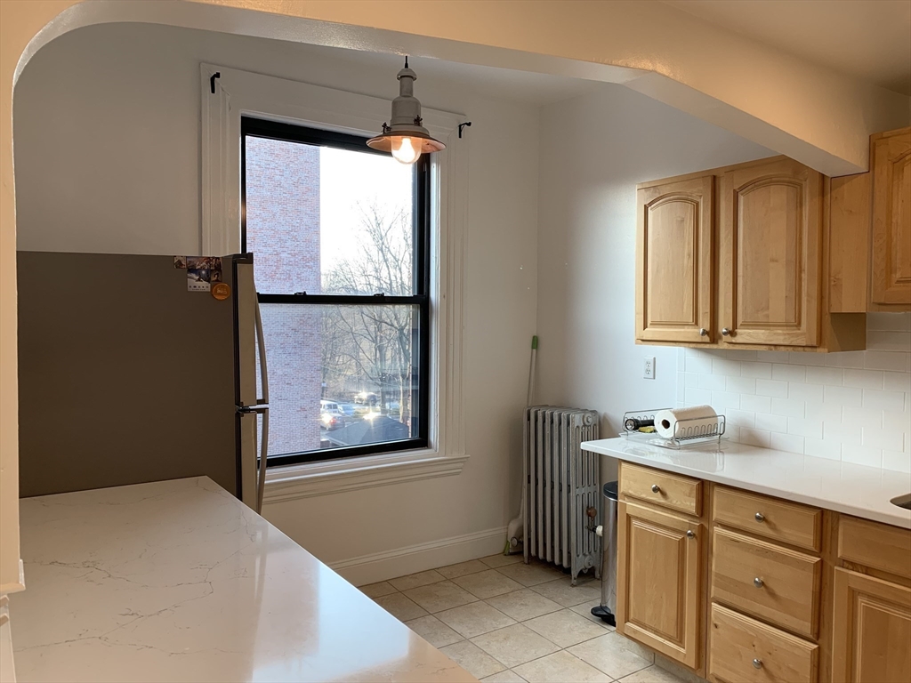1064 Beacon Street, Unit 9 Brookline, MA 02446 - Photo 7 of 19 a room with window and cabinet