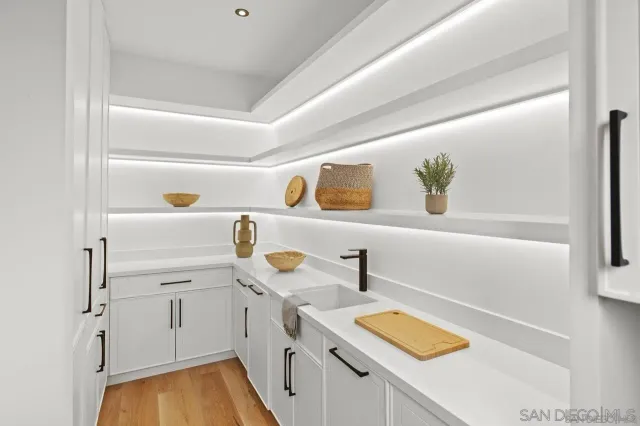 a kitchen with a sink a stove and cabinets